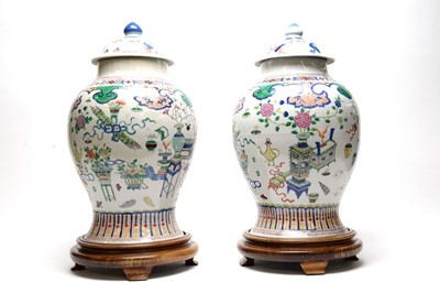 Lot 717 - Pair Chinese Famille Rose vases and covers