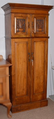 Lot 30 - An early 20th Century Arts & Crafts walnut floor standing cupboard.