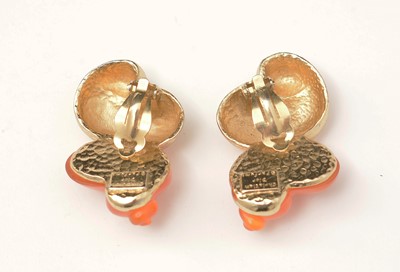 Lot 459 - Christian Dior: a pair of gilt-metal and orange plastic shell pattern clip earrings