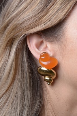 Lot 459 - Christian Dior: a pair of gilt-metal and orange plastic shell pattern clip earrings