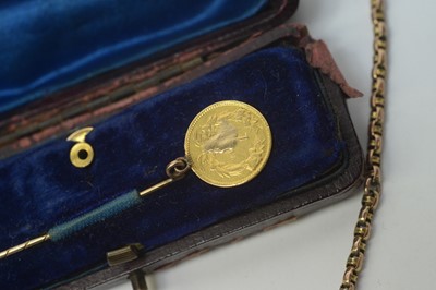 Lot 211 - Gold chain and dollar tie pin.