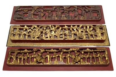 Lot 747 - Three Chinese red and gilt carved wood panels