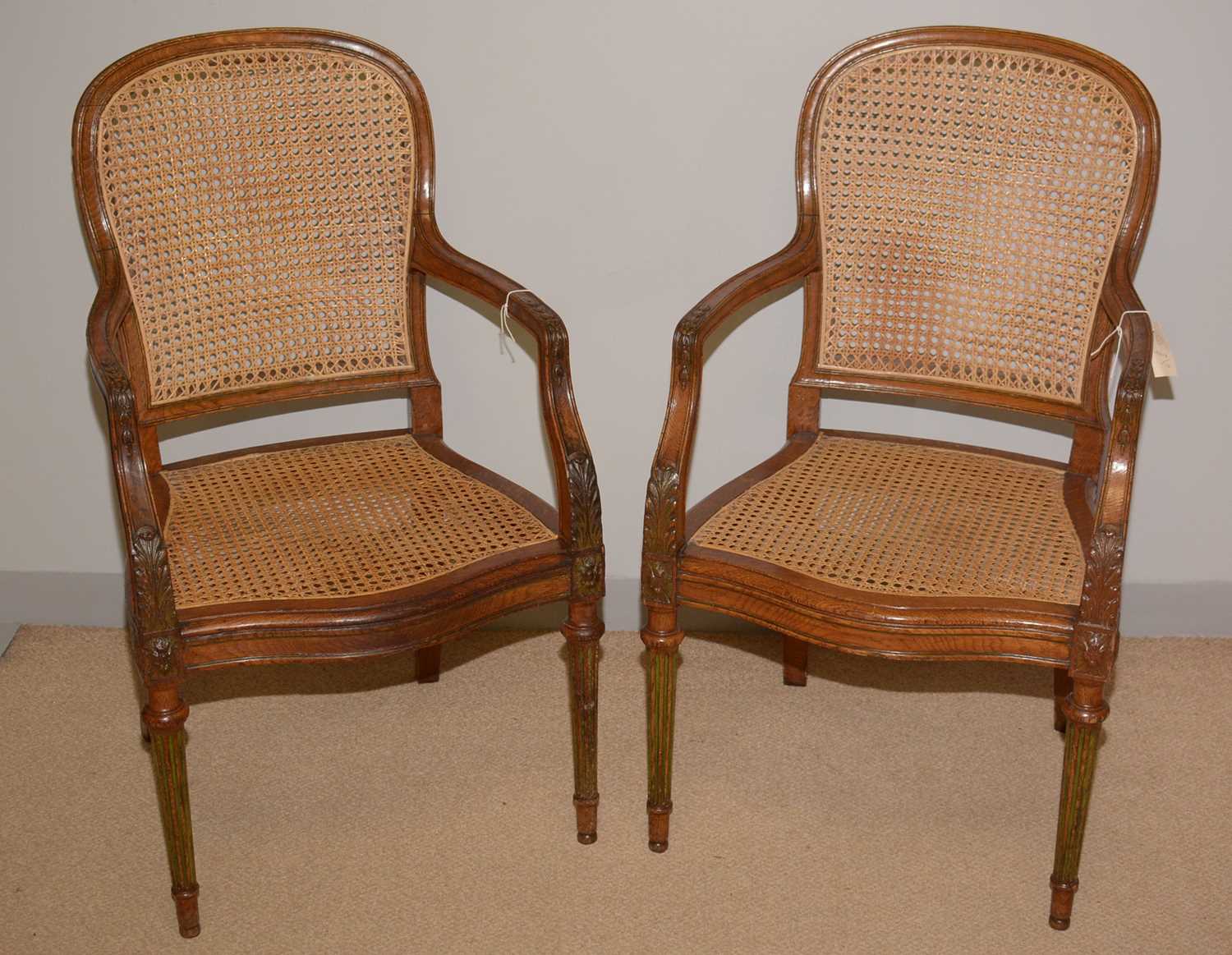 Lot 1 - A pair of late 19th Century French style oak bergere armchairs.