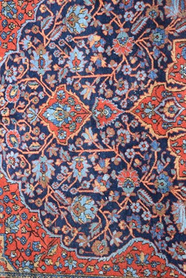 Lot 702 - An antique Kashan rug