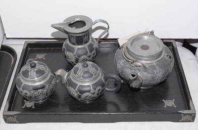 Lot 296 - A Chinese four piece pewter bound tea service.