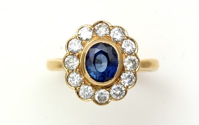 Lot 380 - A sapphire and diamond cluster ring