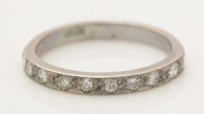 Lot 390 - A ten stone diamond half-hoop eternity ring