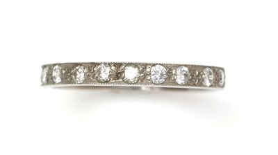 Lot 390 - A ten stone diamond half-hoop eternity ring