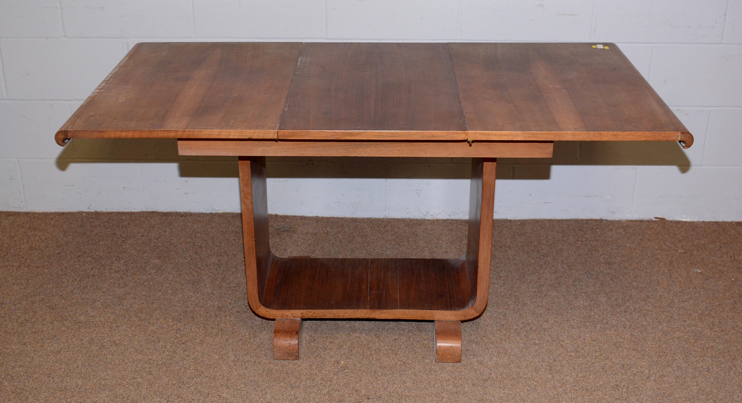 Lot 92 - An Art Deco flamed walnut extending table and