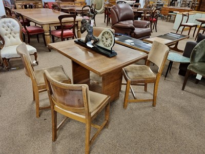 Lot 92 - An Art Deco flamed walnut extending table and four chairs