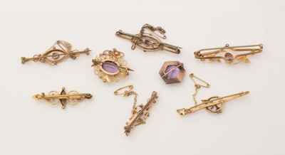 Lot 142 - A selection of amethyst set 9ct. yellow gold Edwardian brooches.