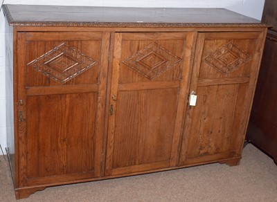 Lot 60 - A carved oak cupboard.
