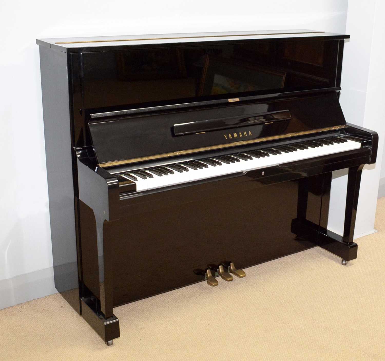 124 - A Yamaha upright piano.