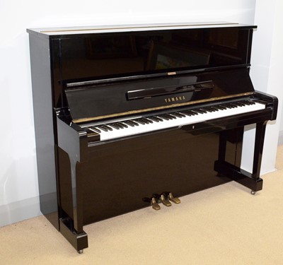 Lot 124 - A Yamaha upright piano.