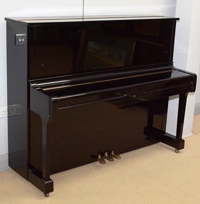 Lot 124 - A Yamaha upright piano.