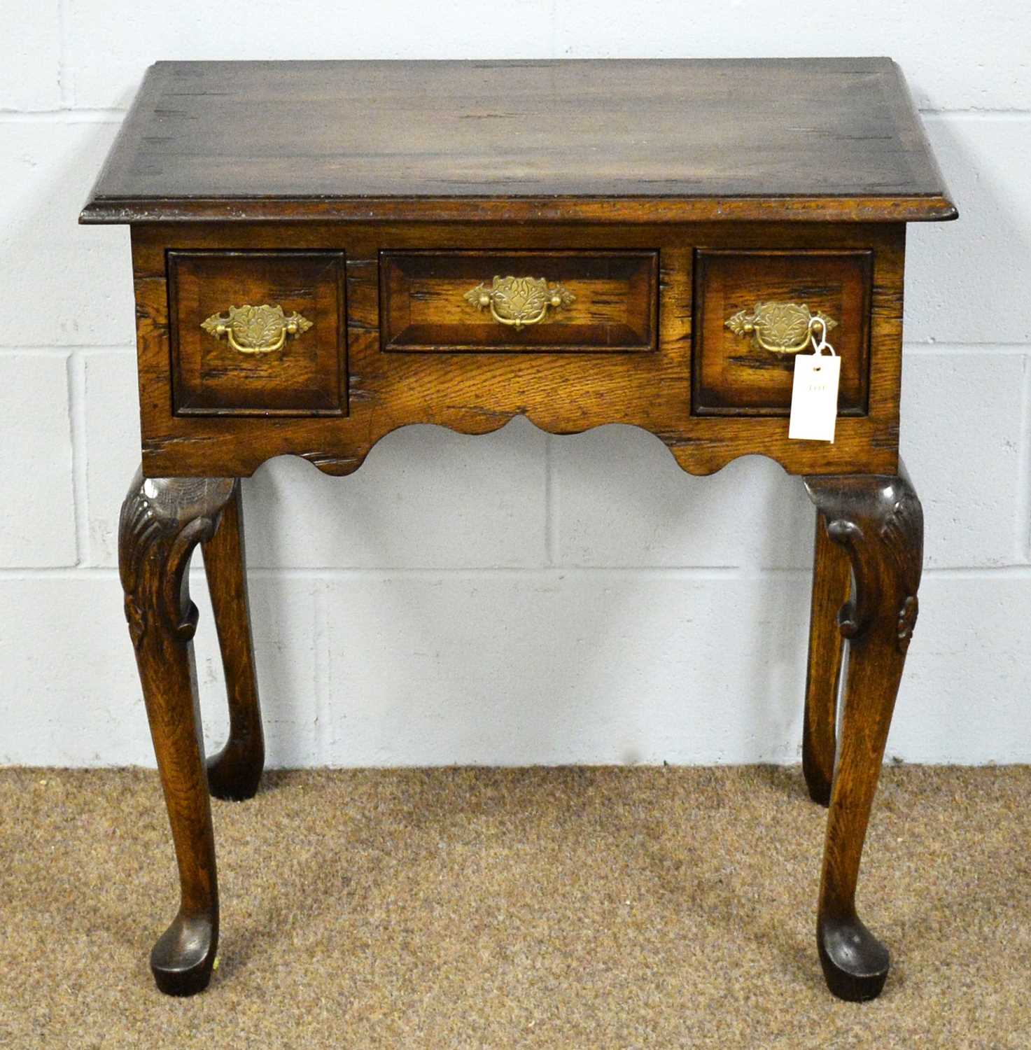 Lot 22 - An 18th Century style ‘stressed’ and banded oak lowboy.