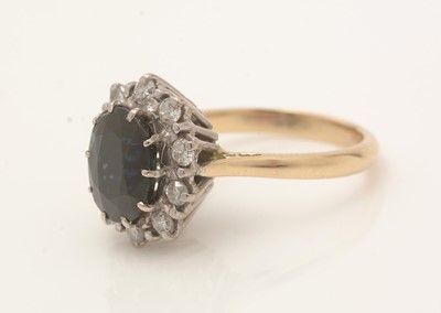 Lot 415 - A sapphire and diamond cluster ring