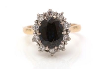 Lot 415 - A sapphire and diamond cluster ring
