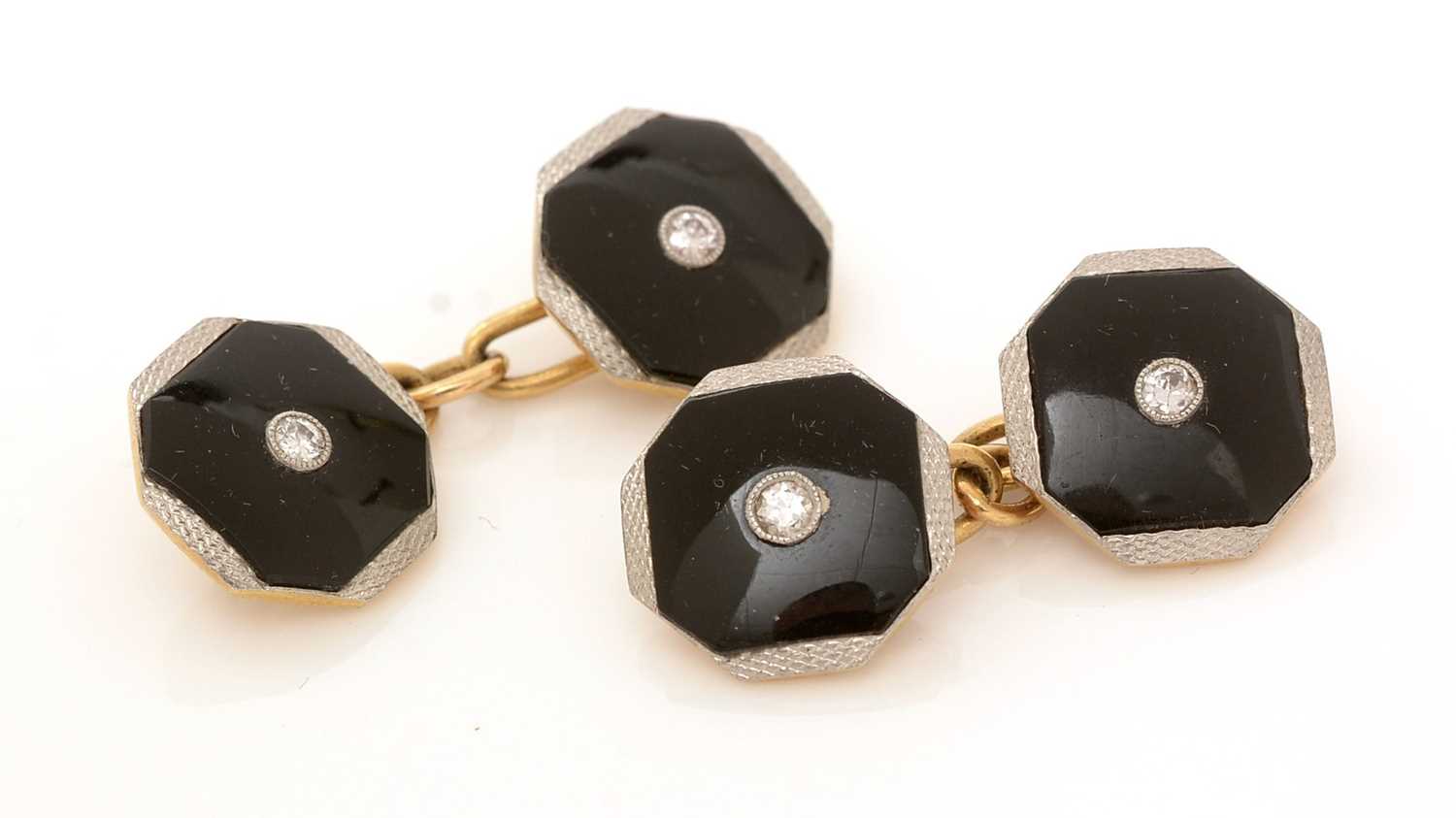 Lot 418 - A pair of diamond and onyx cufflinks