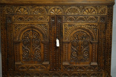 Lot 71 - A large and ornate carved oak cupboard
