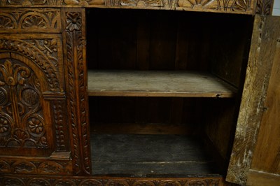 Lot 71 - A large and ornate carved oak cupboard