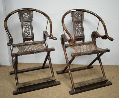 Lot 41 - A pair of Chinese hardwood horseshoe-back folding chairs