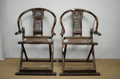 Lot 41 - A pair of Chinese hardwood horseshoe-back folding chairs