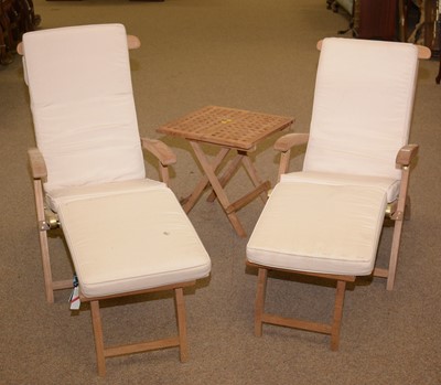Lot 44 - A pair of modern reclining garden chairs; and a folding table.