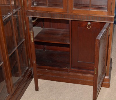 Lot 78 - A Victorian-style mahogany two-piece corner bookcase.