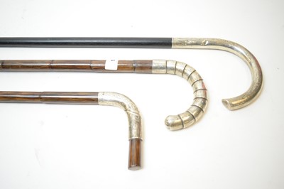 Lot 216 - Two silver topped bamboo walking canes; and another.