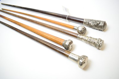 Lot 215 - A silver capped swagger stick and four walking sticks.