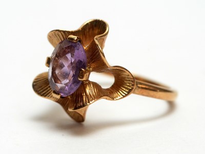 Lot 111 - An amethyst ring, a topaz ring and an eternity ring.