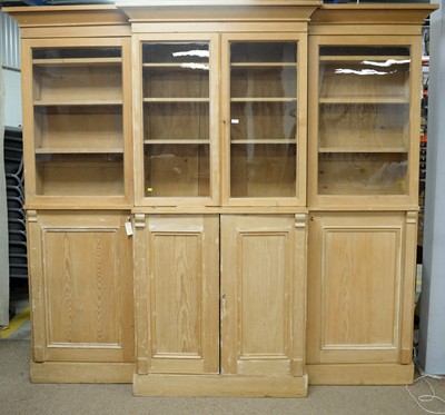 Lot 69 - A substantial pine breakfront bookcase/ display case