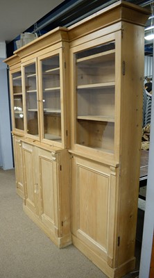 Lot 69 - A substantial pine breakfront bookcase/ display case