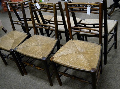 Lot 72 - Six 19th Century rustic oak and ash rush seated dining chairs: and a Georgian elbow chair.