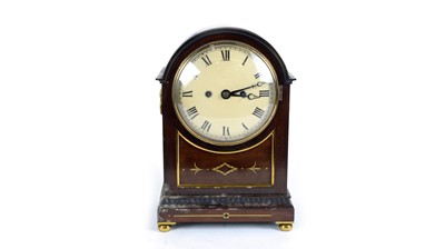 Lot 1202 - A Victorian mahogany and brass inlaid mantel clock.