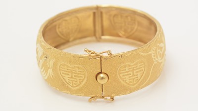 Lot 446 - A high carat yellow gold Chinese bangle