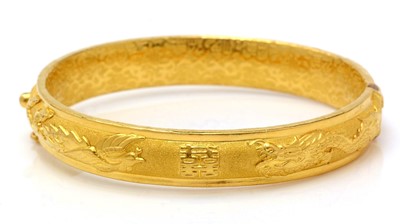 Lot 447 - A high carat yellow gold Chinese bangle