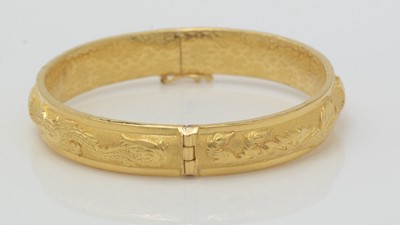 Lot 447 - A high carat yellow gold Chinese bangle