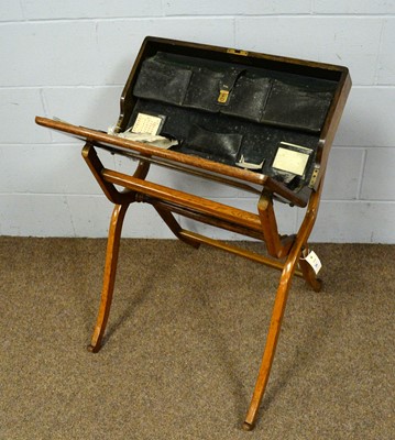 Lot 29 - An early 20th Century oak campaign folding writing desk.