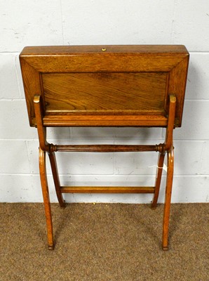 Lot 29 - An early 20th Century oak campaign folding writing desk.