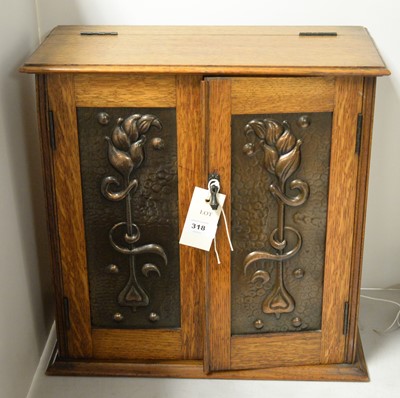 Lot 318 - An Art Nouveau oak smokers cabinet.