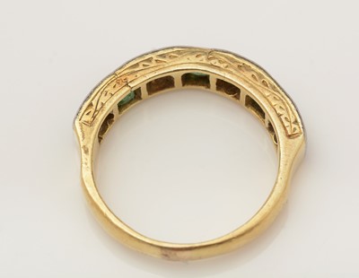Lot 350 - An emerald and diamond half-hoop eternity ring