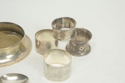 Lot 102 - A selection of silver napkin rings, and a silver mounted pot cover.