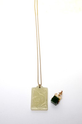 Lot 182 - A nephrite pendant and another on gold chain.