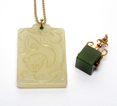 Lot 182 - A nephrite pendant and another on gold chain.