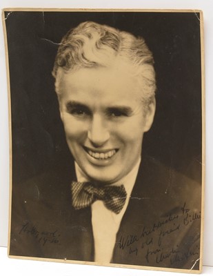 Lot 718 - Charles Chaplin (1889-1977): a signed black and white portrait photograph