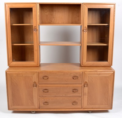 Lot 348 - Ercol: an elm Windsor sideboard and display cabinet.