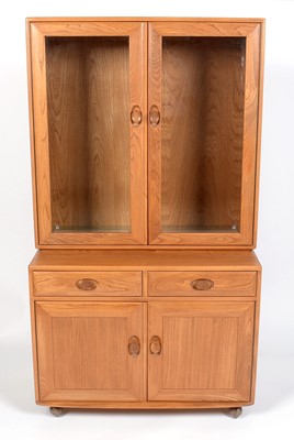Lot 350 - Ercol: an elm Windsor glazed cabinet,.