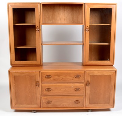 Lot 354 - Ercol: an elm Windsor sideboard and display cabinet.